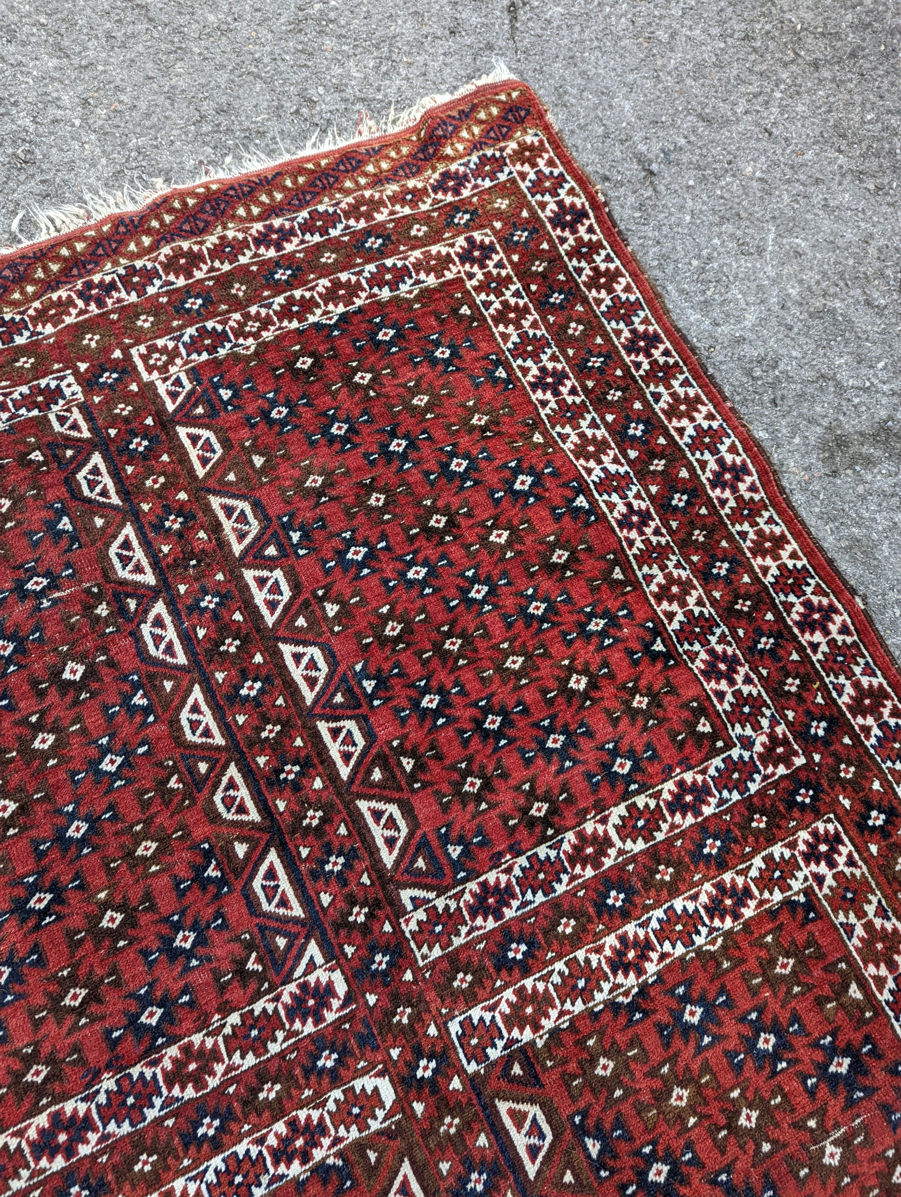 A Belouch red ground rug, 200 x 130cm